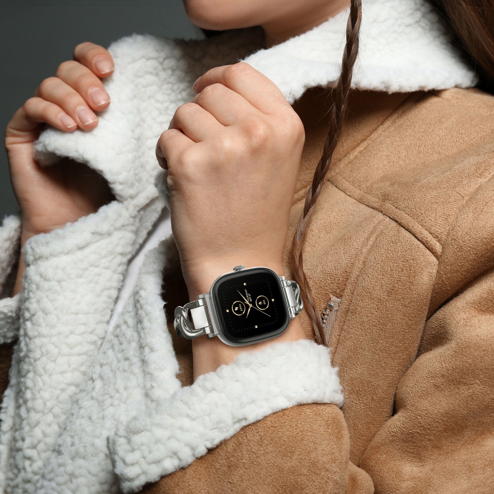 woman in suede and fur lined jacket wearing smartwatch